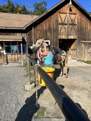 Horse and owner preparing for ride.