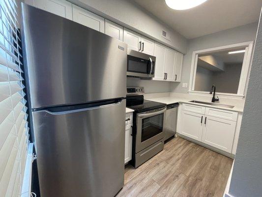 Newly renovated kitchen featuring stainless steel appliances at Scarlet Pointe Apartment Homes located in Charlotte, NC.