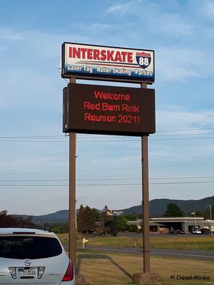 Interskate 88 sign with electronic board welcoming Red Barn Rink reunion.