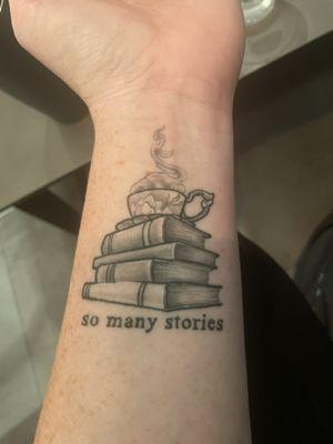 Books and tea mug tattoo on wrist