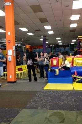 a staff member (yellow) sitting on an inflatable