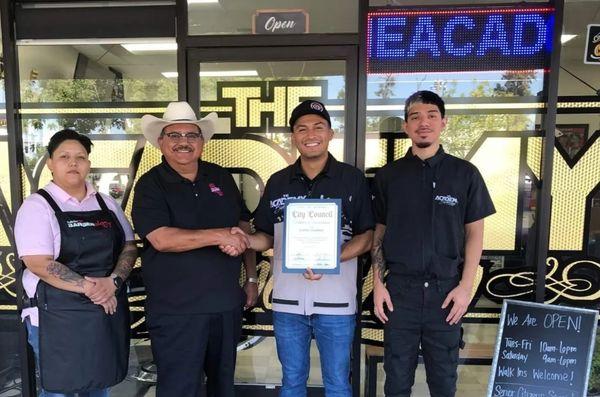 Recognized for providing free ‍cuts at the Back to School event. Mayor Santos G, Owner/Barber Carlos G, Barber Matt G, Barber Ana M.