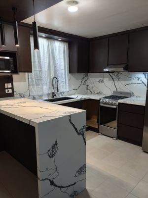 Kitchen countertop renovation with waterfall and full backsplash.