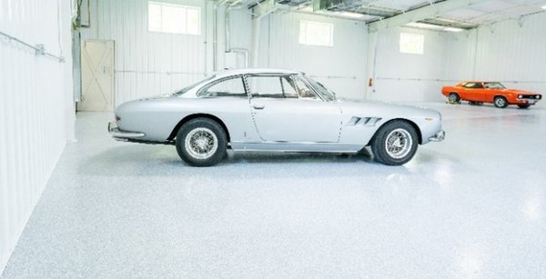 Antique Ferrari and vintage Chevy in storage facility