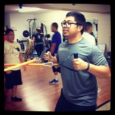 Ervin doing the row on resistance bands in the group training circuit