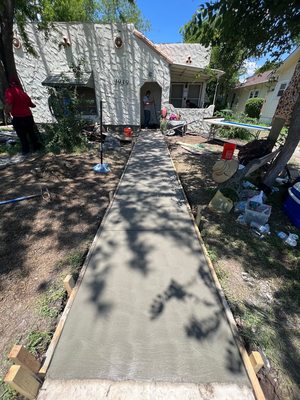 Concrete walkway towards house.