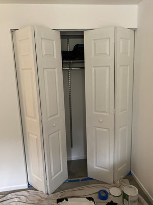 Bifold closet door install and painted with a semi gloss white paint.