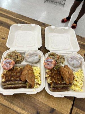 Big breakfast plate with country potatoes two wings a waffle eggs biscuits and gravy