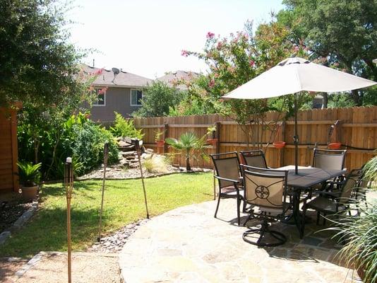 Custom patio with outdoor kitchen. Along back fence - Garden, Pond, Waterfall with gas flame for a nice night time effect...