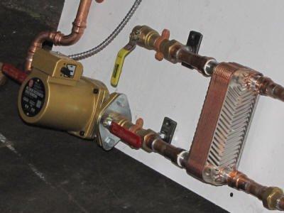 Close up of plate type H.E. and bronze pump for use of outdoor wood boiler as heat source