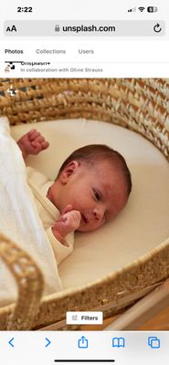 Newborn baby in a bassinet