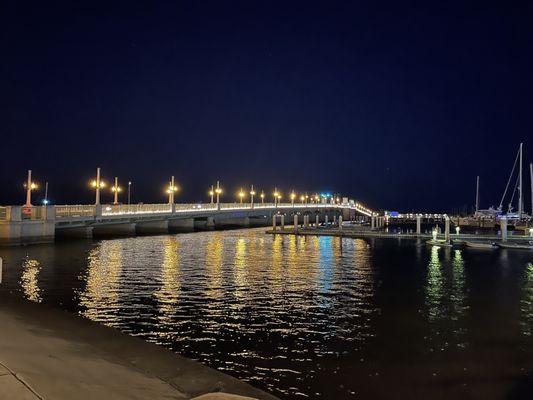 Beautiful nighttime shot of the night lights reflecting on the river below.