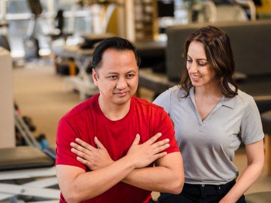 Therapist helping patient with exercise