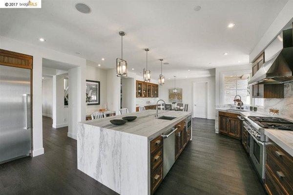 Kitchen: Full overlay, frameless Walnut Cabinetry with a clear conversion varnish "satin" sheen finish.