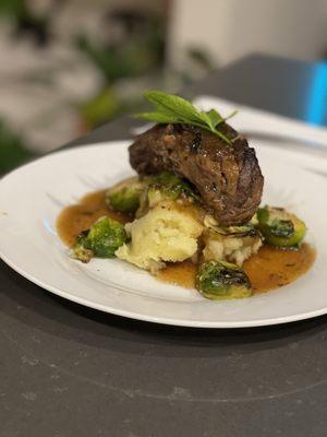 Braised short ribs served with Garlic mashed potato and sautéed Brussel sprouts