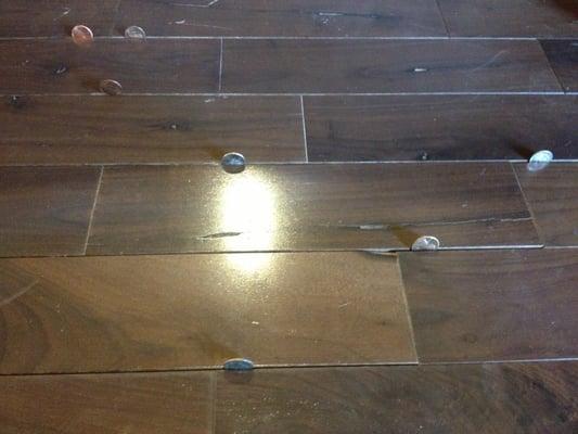 The gaps in our hardwood floor installed by Rhino Rhenovators