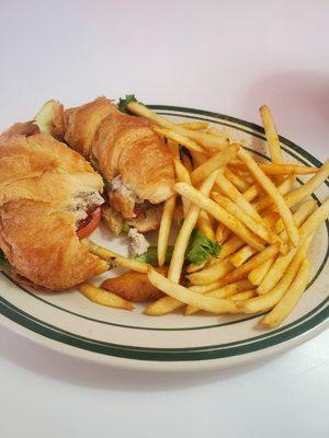 Tuna salad on a buttery cuisant with Avocado added and shoestring fries.