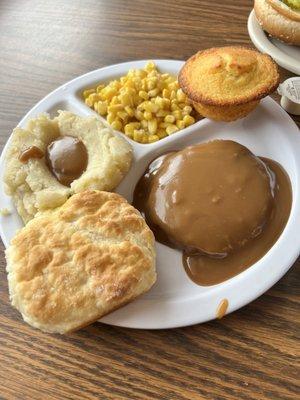 Salisbury steak with two sides, cornbread and biscuit