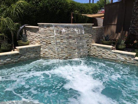 Nice water feature to hide the pool equipment.