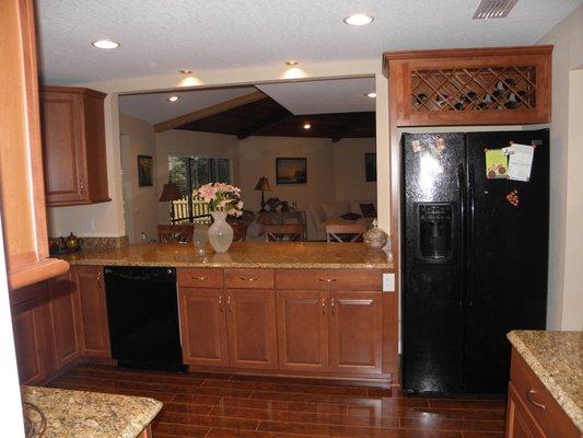 Traditional with a big seating space, opening that window really made the kitchen.  They had black appliances and it looks good.