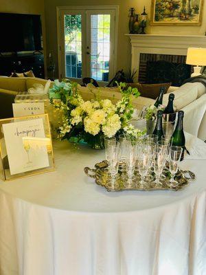 Round table, champagne bucket, and silver tray provided by encore