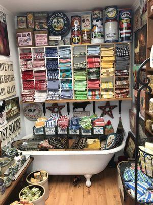 Kitchen towels, braided trivets and antique canisters