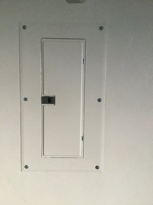 I painted the new, sleek panel board the same color as the wall using primer paint for metal.