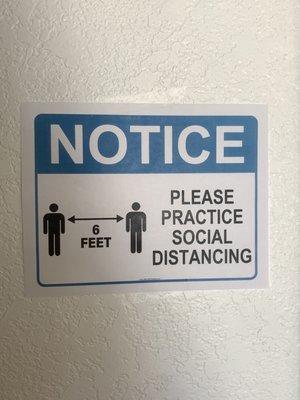 Social distancing sign posted throughout the church