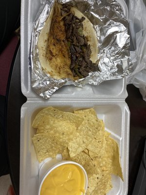 Chips and Queso along with a Fajita taco