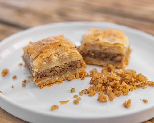 Baklava:
  sweet treat is a layered pastry, made with filo dough, filled with chopped walnuts, and topped with our handmade syrup