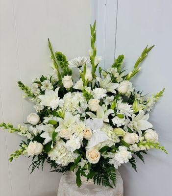 Beautiful all white arrangement. Snapdragons lilies, hydrangeas roses and more.