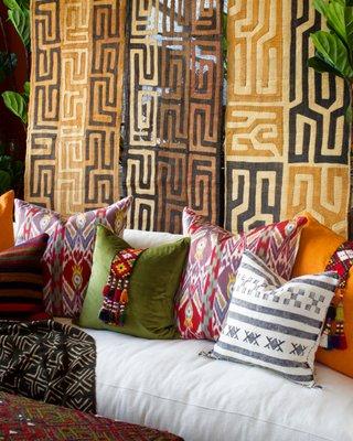 Kuba cloth panels make a beautiful backdrop for ikat and sabra pillows on one of our performance fabric sofas.