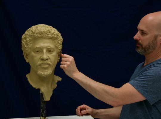 Sutton working on a bust of Bez