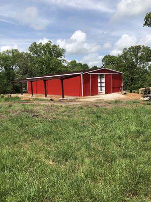 Red Iron Barn going up with sliding doors.