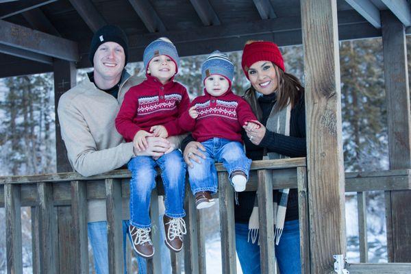 Outdoor wintertime portraits on covered bridge in Red River, New Mexico