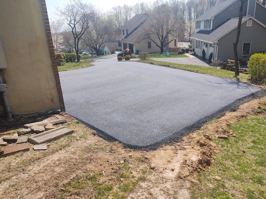 Extended driveway off a two-car garage for a third car.