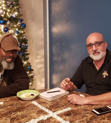 Two members of our cigar family enjoying a friendly game of Dominoes