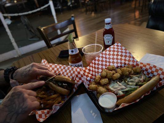 Philly cheesesteak sandwiches with french fries and tater tot's and a margarita with a Modelo beer Can't wait to taste more of their food