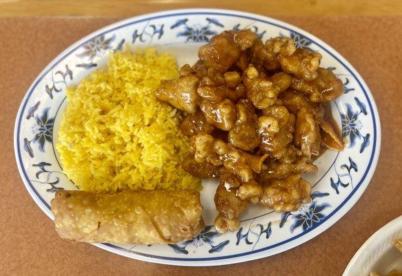 Orange chicken with fried rice and egg roll. If you look closely you can see the orange peel. Yum!