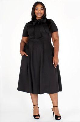 Black plus size dress with a tie front and pockets.