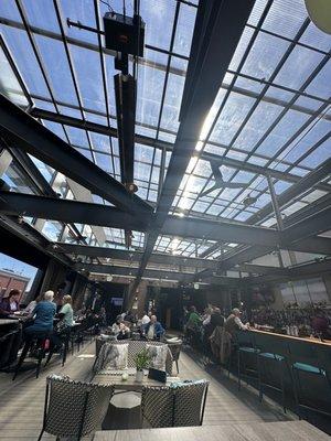 Natural sunlight, covered by a translucent roof and screen in windows for comfy dining.