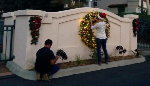 Our elves hanging holiday lights