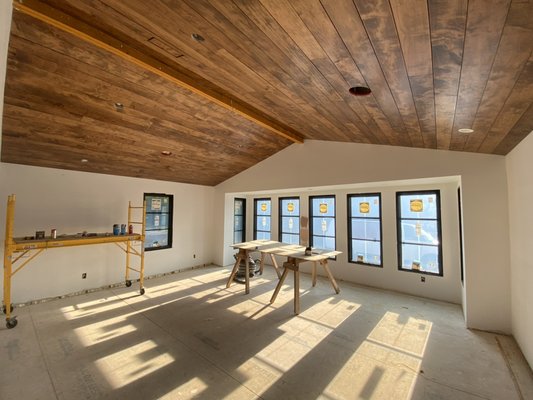 Shiplap ceiling (beam not installed yet in photo) stained and installed