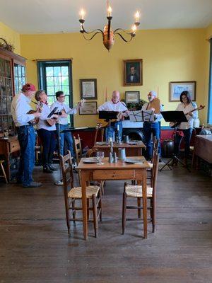 A folk band plays for a party at the Tavern