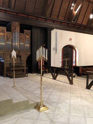 Organ and candelabras at the front of the chapel.