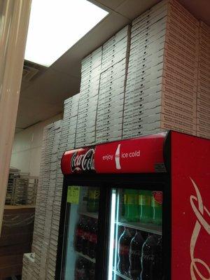 Pizza boxes stacked to the ceiling.