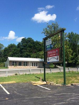 New sign along with view from our new parking lot looking @ our old spot.