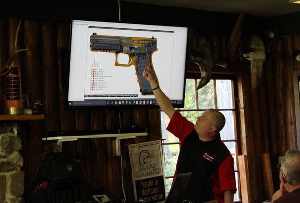 Classroom teaching semi-auto pistol operation detail.