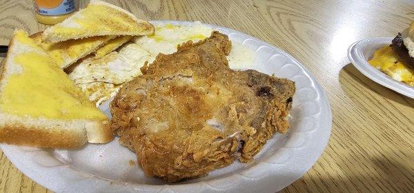 Pork Chop with eggs and toast.