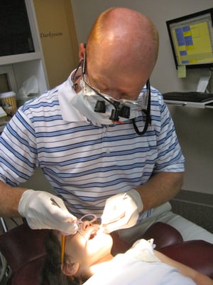 Dr. Smith examining my daughter's teeth. She feels so comfortable with him.